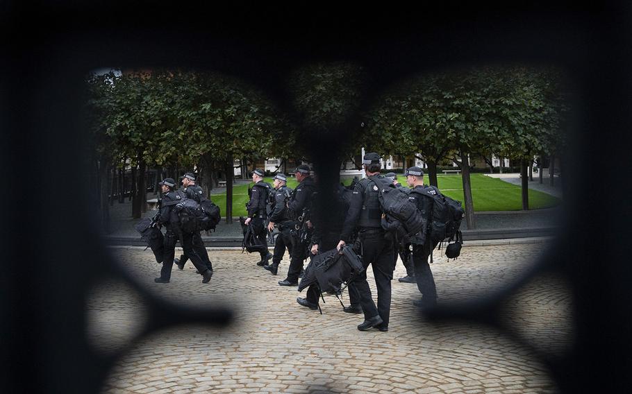 Police officers enter the grounds of the Palace of Westminster in London on Sept. 15, 2022.