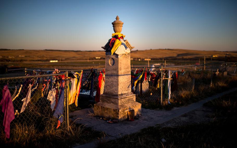 Peace offerings of tobacco ties adorn the fence at the Wounded Knee Memorial on the Pine Ridge Reservation in South Dakota on Oct. 20, 2014. 