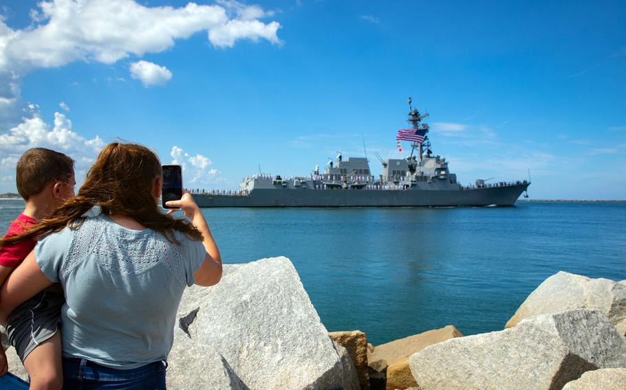 Family members of sailors photograph the departure of the destroyer USS Delbert D. Black from Naval Station Mayport, Fla., on Aug. 2, 2022. 
