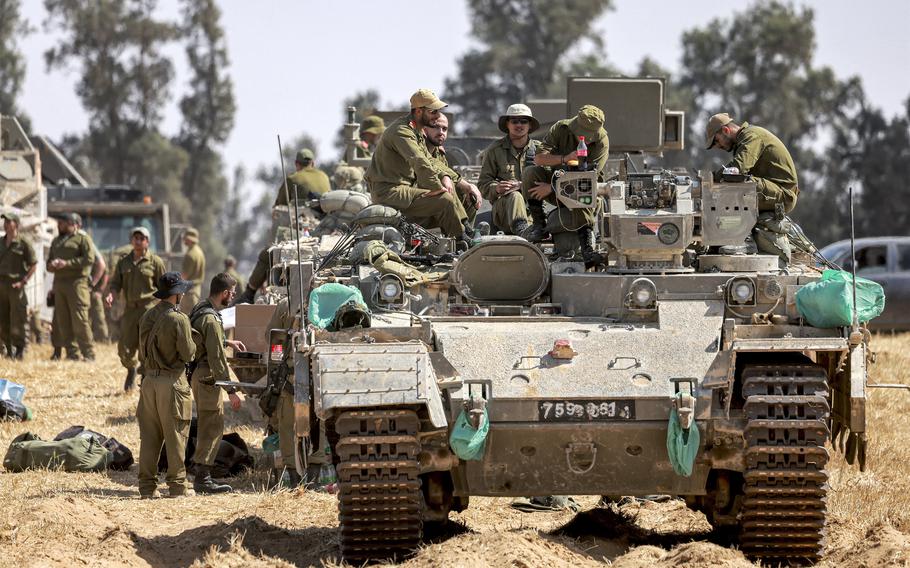 Israeli army soldiers sit atop an infantry-fighting vehicle (IFV) positioned near the border with the Gaza strip in southern Israel on Tuesday, April 30, 2024, amid the ongoing conflict in the Palestinian territory between Israel and the militant group Hamas.
