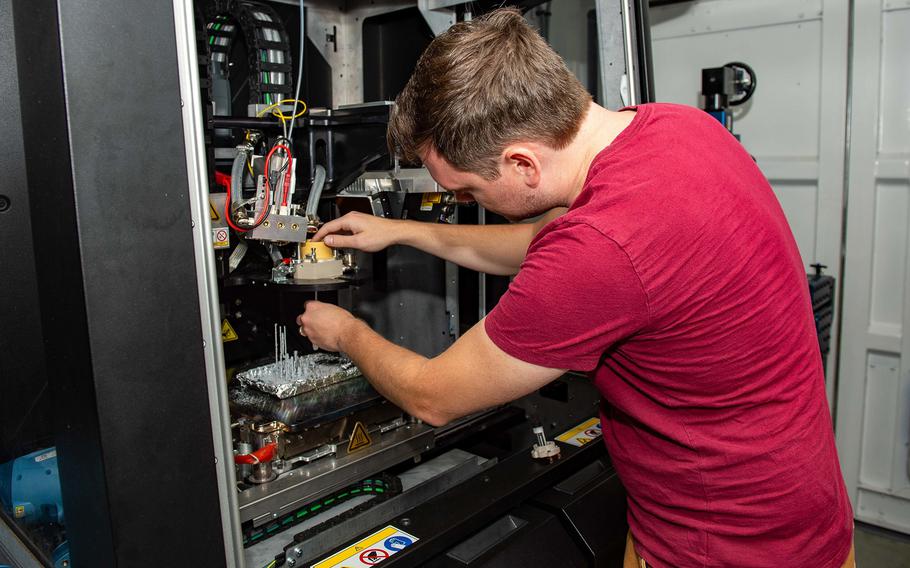 Xerox technician Dan Porter assembles an ElemX 3D printer head aboard the amphibious assault ship USS Essex at Pearl Harbor, Hawaii, July 9, 2022. 