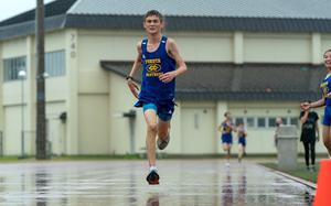 Navigating a morning downpour, Yokota's Richard Scheffler crosses the finish line first in Saturday's DODEA-Japan cross country race at Misawa Air Base. Scheffler was timed in 18 minutes, 26.4 seconds and the Panthers placed first in the boys team standings.