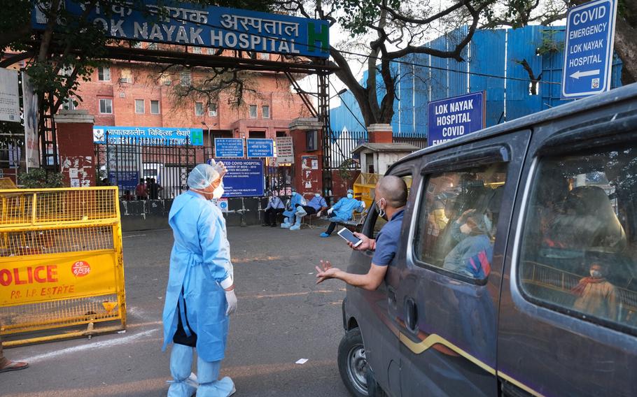 Health workers turn away a vehicle at the main entrance of the Lok Nayak Jaiprakash Hospital in New Delhi on April 25, 2021.