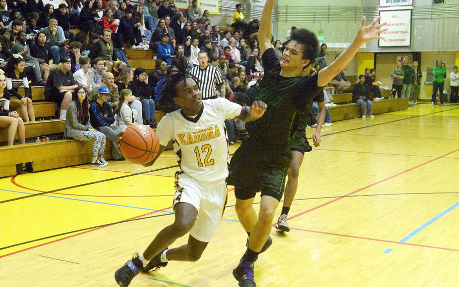 Kadena's DeShaun Nixon dribbles against Kubasaki's Ryan Hater during Friday's Okinawa boys basketball game. The Panthers won 49-44, completing a four-game season-series sweep of the Dragons.