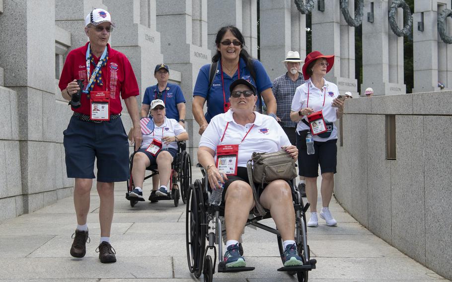 Retired Air Force Senior Master Sgt. Rhonda Storey arrives at the World War II Memorial on the National Mall in Washington, D.C., on Tuesday, May 31, 2022. Pushing her wheelchair is volunteer Honor Flight Guardian Karen Monsen, the daughter of a World War II veteran.