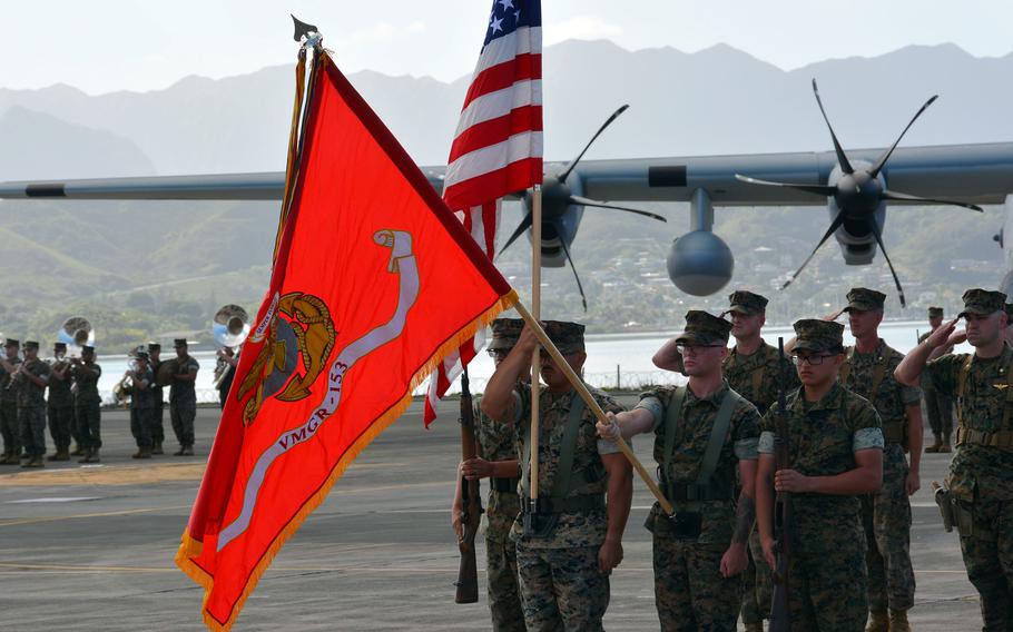 Marines carry the newly unfurled colors of Marine Aerial Refueler Transport Squadron 153 during a ceremony at Marine Corps Base Hawaii, Friday, Jan. 13, 2023.