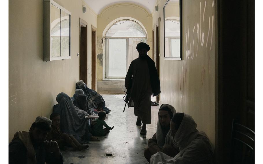 A group of women, left, wait to be received by a judge in the criminal court of law in Kandahar, Afghanistan. 