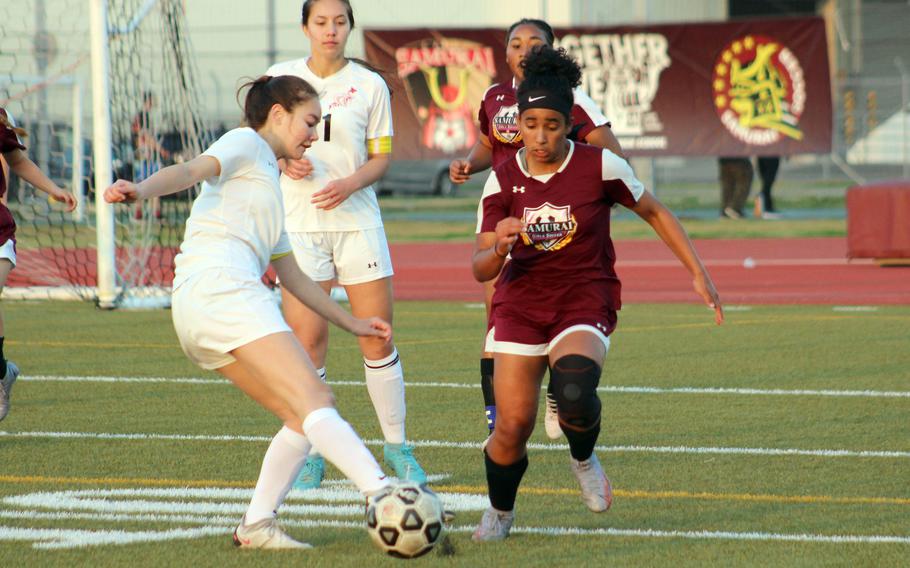 E.J. King's Aileen FitzGerald plays the ball in front of Matthew C. Perry's Ivanelis Nieves-Bermudez during Friday's DODEA-Japan girls soccer match. The Samurai won 1-0, their first win over the Cobras this season.