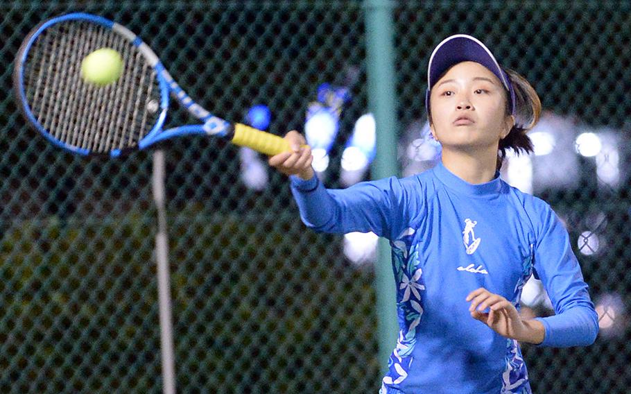 Yokota's Julia Morioka smacks a forehand return against Christian Academy Japan's Jahnari Paramata during Wednesday's Kanto Plain tennis matches. Paramata won 8-4.