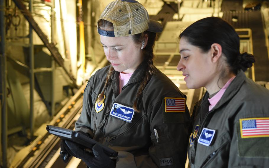Staff Sgt. Devyn Freeze, left, and Senior Airman Marissa Antillonloya, loadmasters with the 37th Airlift Squadron at Ramstein Air Base, Germany, prepare for a training flight on March 18, 2022. The two were part of an all-women training mission, the first ever conducted by the squadron, in commemoration of Women’s History Month.