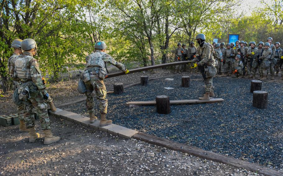 Air Force trainees navigate a teamwork obstacle course at Joint Base San Antonio-Chapman Training Annex, Texas, on Oct. 26, 2022. The course challenged trainees' ability to solve problems posed by PACER FORGE field training.