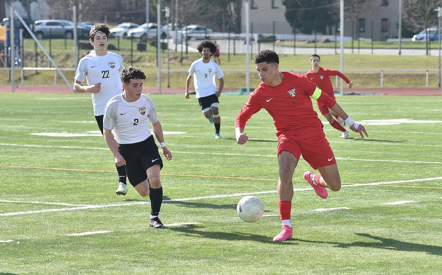 Kaiserslautern forward Aaron Zamor dribbles as Stuttgart's Gabriel Maples defends during a boys soccer match on March 9, 2024, at Kaiserslautern High School in Kaiserslautern, Germany.