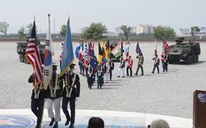 Service members carry member nation flags during a ceremony marking U.N. Command's 75th anniversary at Camp Humphreys, South Korea, July 8, 2025.