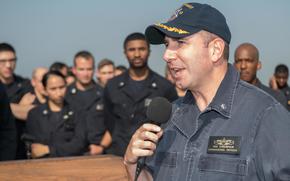 171024-N-OW019-002 U.S 5TH FLEET AREA OF OPERATIONS (Oct. 24, 2017) Cmdr. Theodore Essenfeld, commanding officer of the amphibious dock landing ship USS Pearl Harbor (LSD 52), speaks during an all-hands call on the ship’s flight deck. Pearl Harbor is part of the America Amphibious Ready Group (ARG) and, with the embarked 15th Marine Expeditionary Unit (MEU), is deployed in support of maritime security operations and theater security cooperation efforts in the U.S. 5th Fleet area of operations. (U.S. Navy photo by Mass Communication Specialist Seaman Logan C. Kellums/Released)
