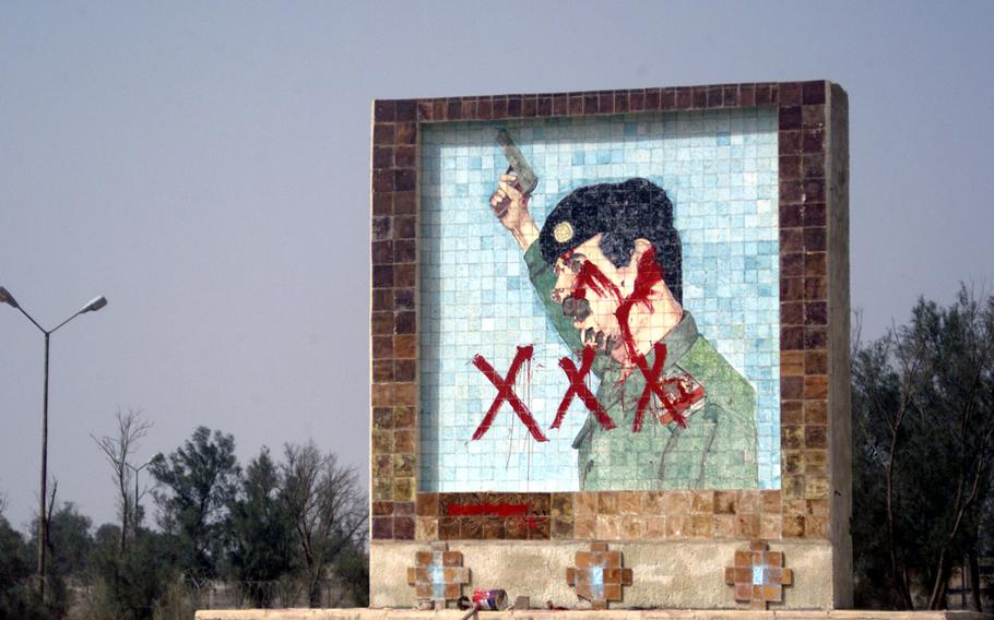 This large mosaic showing Saddam Hussein in the town of Umm Qasr, Iraq, on March 30, 2003, following the U.S.-led coalition's invasion of the country. 