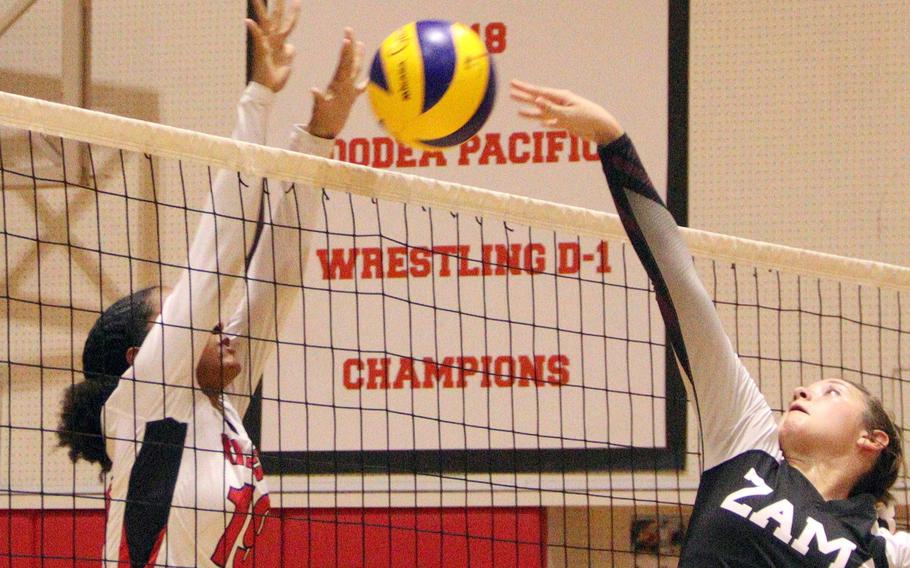 Nile C. Kinnick's Alyssa Staples and Zama's Juliet Bitor battle for the ball at the net during Monday's DODEA-Japan/Kanto Plain volleyball match. The Red Devils won in two sets.