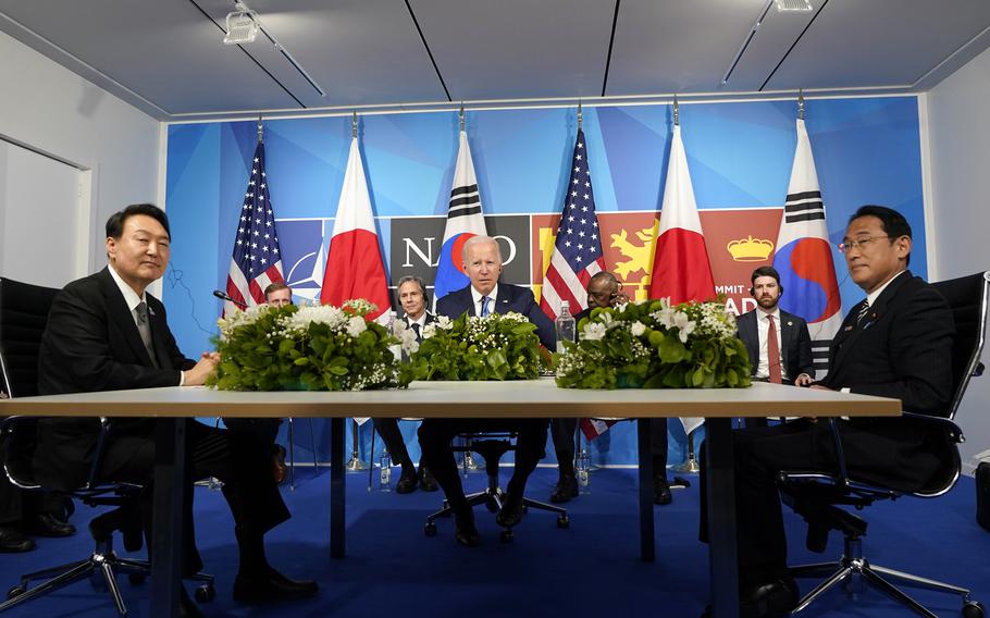 President Joe Biden, center, meets with South Korea's President Yoon Suk Yeol, left, and Japan's Prime Minister Fumio Kishida during the NATO summit in Madrid, on June 29, 2022. 