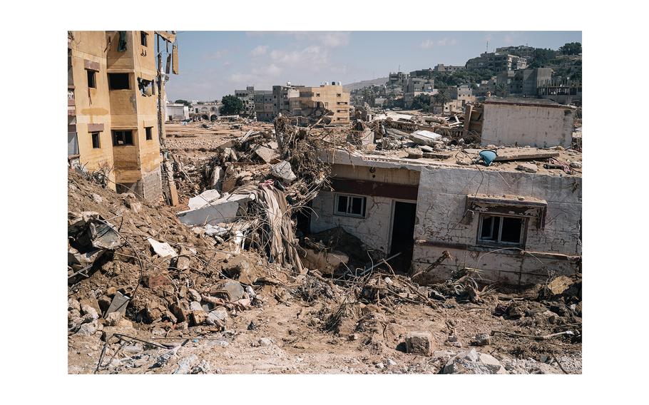 Destroyed houses and buildings in central Derna are partially buried in mud after the deadly flooding last month. 
