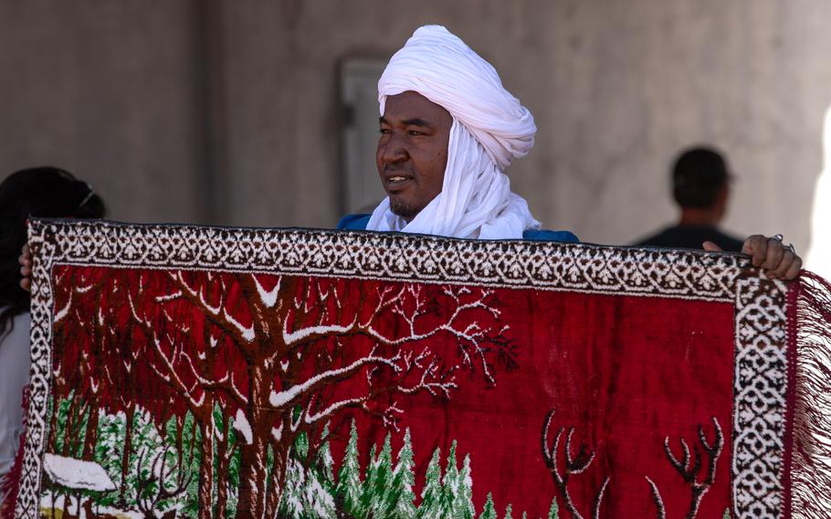 An Agadez vendor displays a rug during a bazaar at Air Base 201, Niger, March 2, 2024. A split with the U.S. means that Niger can expect to lose out on the hundreds of millions in aid it has received from the U.S. in recent years, possibly hurting the people of Niger economically.