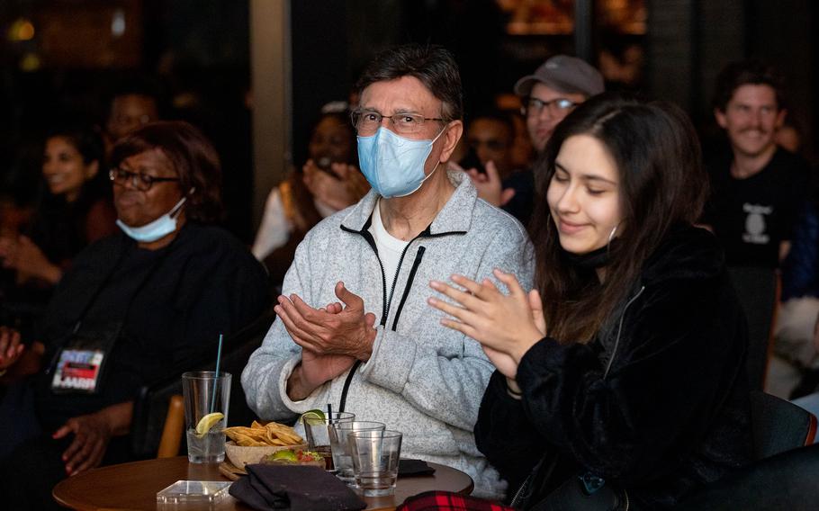 A father-and-daughter duo attend a comedy show in Washington, D.C., on March 14, 2022.