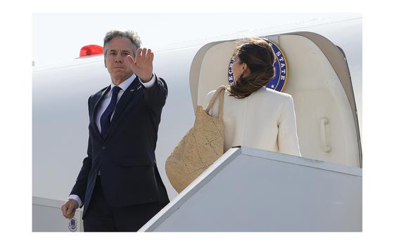 U.S. Secretary of State Antony Blinken gestures, as he and his wife Evan Ryan board a plane at the U.S. Naval Support Activity base, after the G7 foreign ministers summit on Capri island, in Naples, Italy, Friday April 19, 2024. (Ciro de Luca, Pool Photo via AP)