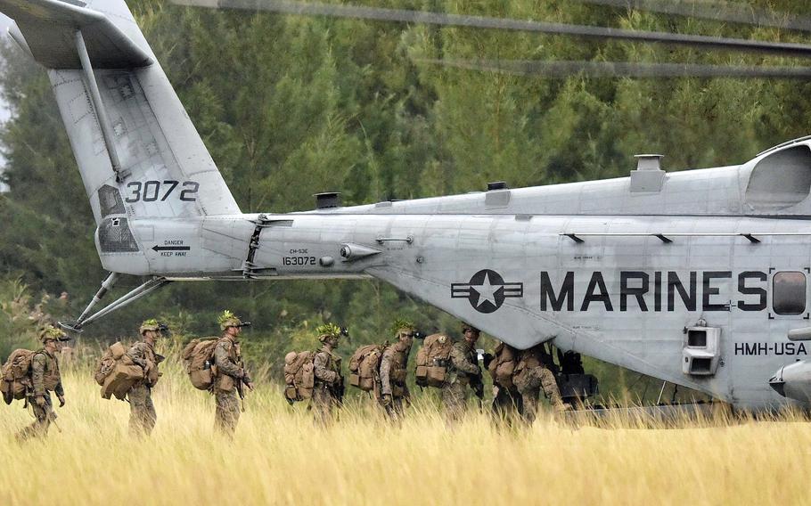 Marines from Alpha Company, 1st Battalion, 2nd Marine Regiment out of Camp Lejeune, N.C., board a CH-53E Super Stallion for an exercise at the Central Training Area on Okinawa, Dec. 7, 2022.