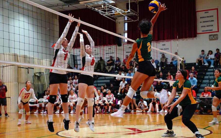Kaleiana Alonzo spikes the ball.