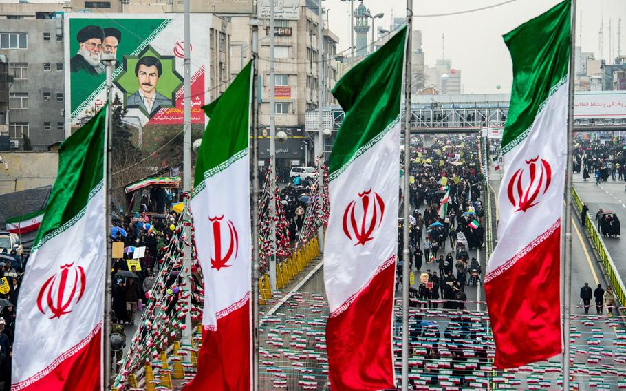 Demonstrators fill the street as Iranian national flag banners fly during the 40th anniversary of the Islamic revolution in Tehran, Iran, on Feb. 11, 2019. 