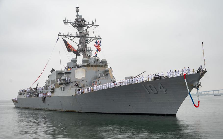 Sailors like the ship as it sails into port.