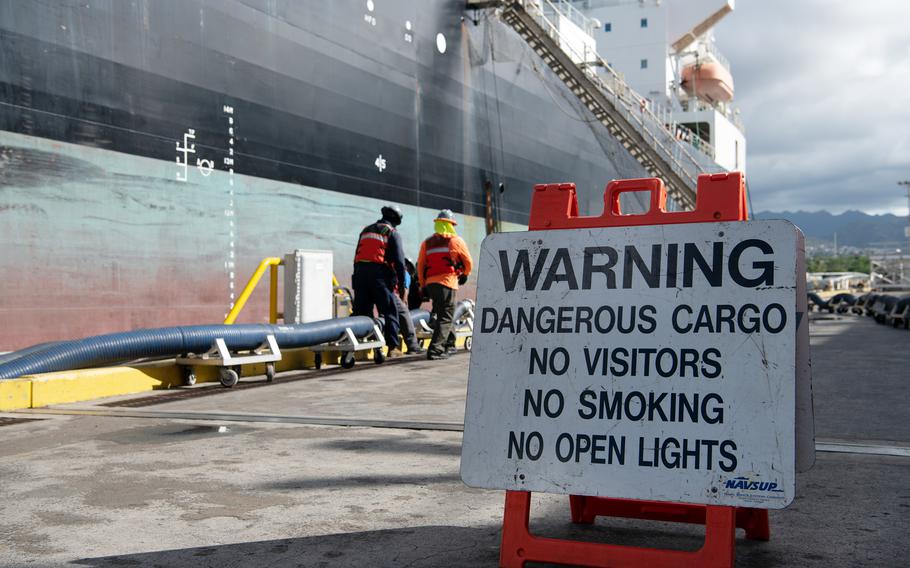 A fuel line is connected to a merchant tanker to transfer fuel from the Red Hill Bulk Fuel Storage Facility in Hawaii, Oct. 23, 2023.