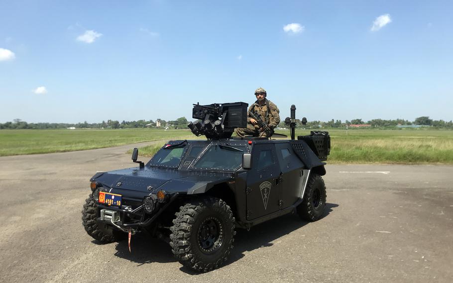 U.S. Marines in an Indonesian military vehicle pave the way for the arrival of a U.S. Army High Mobility Artillery Rocket System at an airfield in Palembang, Indonesia, Tuesday, Aug. 9, 2022.