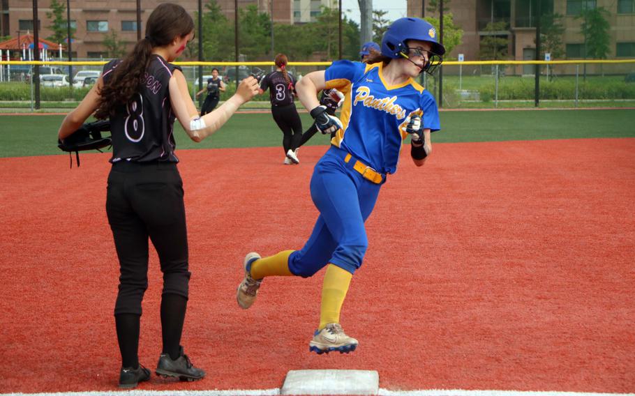 Yokota's Kayla Bogdan rounds third past Perry infielder Miah Apperson toward home.