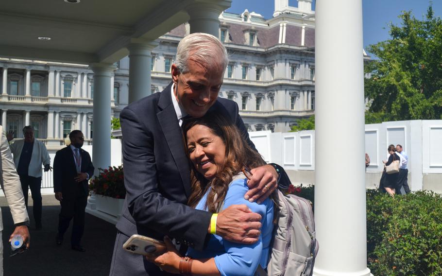 Department of Veterans Affairs Secretary Denis McDonough hugs Rosie Torres, co-founder and executive director of the advocacy group Burn Pits 360. Her husband, Army Reserve veteran LeRoy Torres, deployed to Camp Anaconda in Iraq and returned with terminal lung disease, toxic brain injury and autoimmune issues. Torres began the efforts to lobby for legislation 13 years ago. 