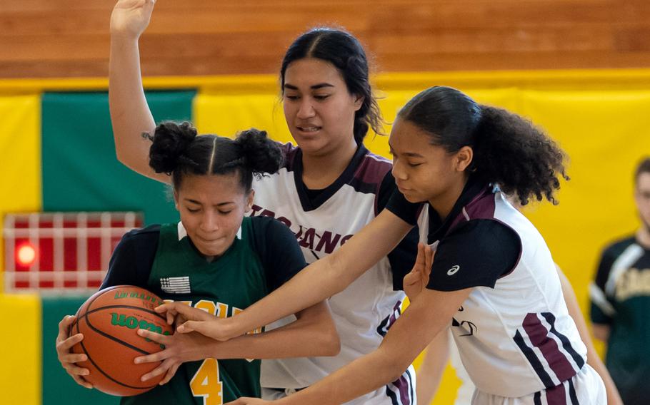 Robert D. Edgren’s A’Mya Ross gets hemmed in by Zama’s Kierstyn Aumua and Naviah Blizzard during Saturday’s DODEA-Japan girls basketball game. The Eagles won 30-25.