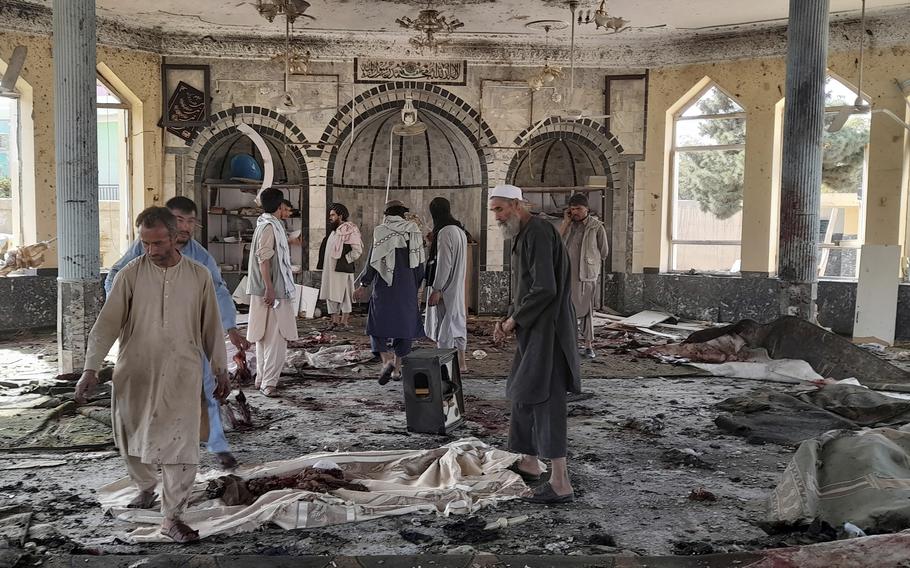 People view the damage inside of a mosque following a bombing in Kunduz, province, northern Afghanistan, Friday, Oct. 8, 2021.
