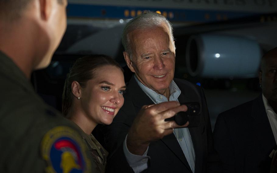 President Joe Biden takes a picture with a service member while visiting Andersen Air Force Base, Guam, on Nov. 16, 2022. Biden will turn 80 on Sunday, Nov. 20, but the White House has few plans to mark the landmark birthday in any major public way.