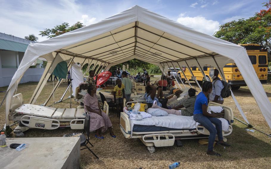 Patients of OFATMA Hospital in Les Cayes, Haiti, are being cared for in tents on Monday, Aug. 16, 2021. Though it did not collapse, the hospital's walls and floor cracked during the earthquake and no one wants to go back inside. 