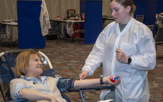Seileen Mullen, principal deputy assistant secretary of defense for health affairs, donates blood at the Armed Forces Blood Program blood drive during the 2024 Military Health System Conference in Portland, Oregon, April 11. Ms. Mullen was assisted by U.S. Army Spc. Taylor Farley, of the 153rd Medical Detachment at Joint Base Lewis-McChord. More than 250 units of blood were donated during the conference.