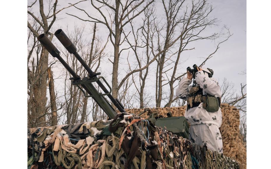 A member of a Ukrainian air defense unit in the back of a truck with a mounted ZU-23-2 north of Kharkiv on Jan. 23, 2024. 