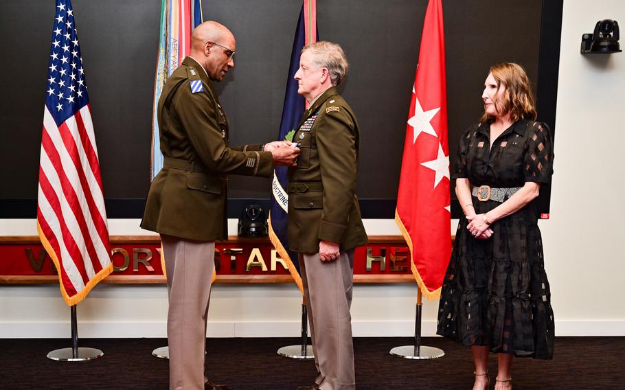 Gen. Gary Brito, commanding general, U.S. Army Training and Doctrine Command, presents retired Army Maj. Larry Moores with the Silver Star during a ceremony in front of family and friends March 25, 2024. Moores’ wife, Retired Army Col. Kerry E. Moores, watches the presentation.