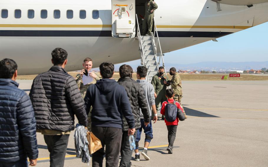 Afghan travelers board a flight bound for the United States from the Pristina Adem Jashari International Airport in in Pristina Kosovo, Sept. 26, 2021. Some evacuees remain at Camp Layla on Camp Bondsteel while awaiting their administrative processing.