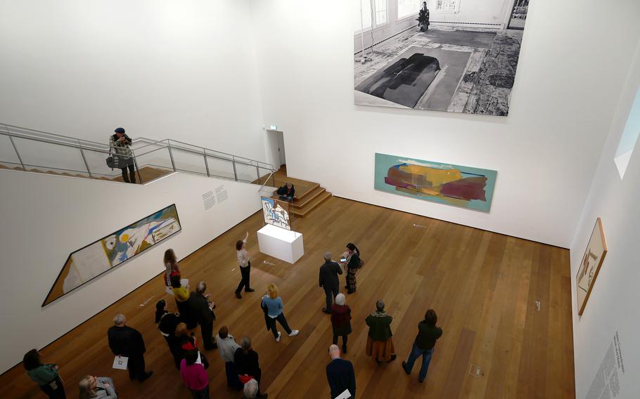 The press looks at paintings by American artist Helen Frankenthaler hanging in a museum