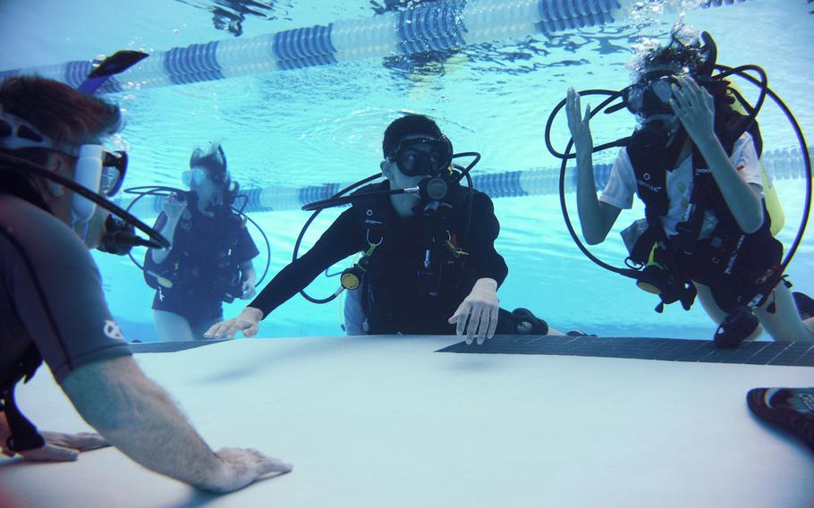 Patriot Scuba, training dive students at George Washington Rec Center in Arlington, Va., helps divers qualify for certification using adaptations as needed for injuries or disabilities. 