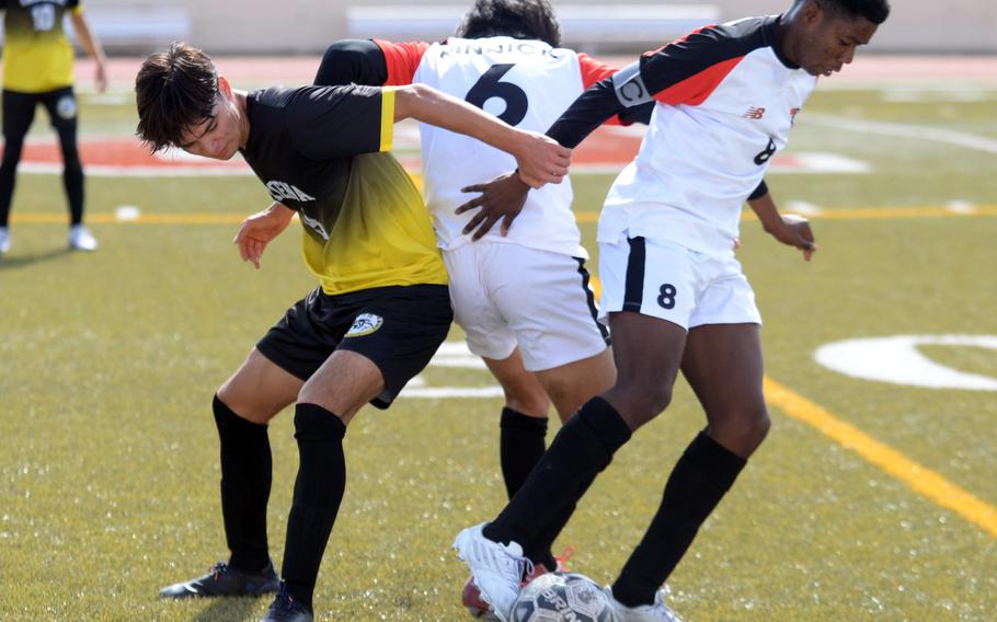 Kadena's Tuck Renquist and Nile C. Kinnick's Takuya Raqueno and Leon Awesso scramble for the ball during Saturday's Perry Cup Gold Group match. The Panthers won 2-0, capturing the group and championship by goal differential.