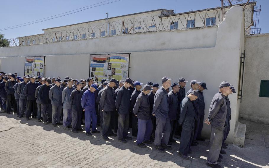 Prisoners line up for lunch outside the Russian prisoner of war detention camp on Aug. 3, 2023, in the Lviv region, Ukraine. Hundreds of captured Russian POWs including conscripts, mercenaries, Wagner militia and Storm-Z Russian prisoners are being held in up to 50 sites around Ukraine. Storm-Z is a series of penal military units established by Russia since April 2023.