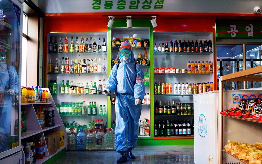 An employee of the Kyonghung Foodstuff General Store disinfects the showroom in Pyongyang, North Korea, Wednesday, Nov. 10, 2021.