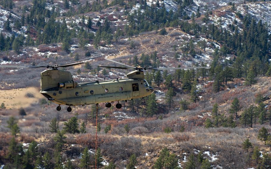 Firefighters from the U.S. Air Force Academy, Fort Carson and the Colorado Springs Fire Department dump water from air assets in their fight against the West Monument Creek Fire on the U.S. Air Force Academy on Monday, Feb. 26, 2024.