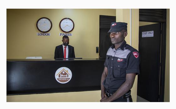 A security guard on June 10, 2022, stands in the reception area of the Hope Hostel in the Kigali, Rwanda, one of the locations expected to house some of the asylum-seekers due to be sent from Britain.