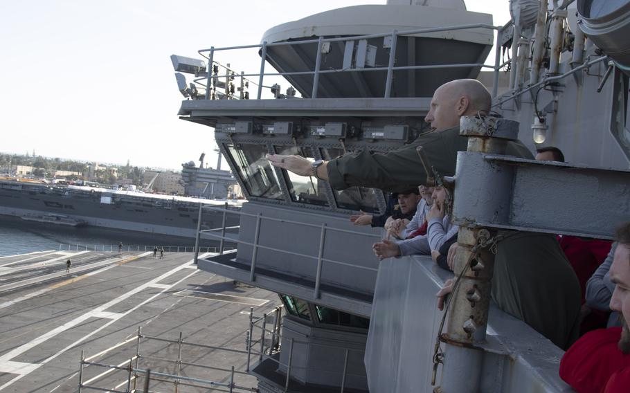 Commanding Officer Capt. Pete Riebe explains how flight operations are conducted during an open ship tour aboard the Nimitz-class aircraft carrier USS Abraham Lincoln prior to the 2023 Holiday Bowl, Dec. 24, 2023. 