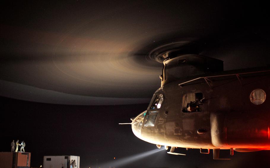 National Guard soldiers with Company B, 2nd Battalion, 211th General Support Aviation Battalion, transport containers with a CH-47 Chinook during sling load operations in Balad, Iraq, in February 2011. Company B was composed of both Iowa and Minnesota National Guard soldiers and provided the only Chinook helicopter support for the entire Iraq theater during their deployment as part of Operation New Dawn. 